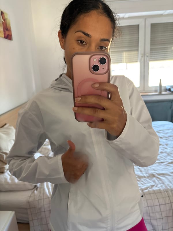 Person photographs athletic outfit in bedroom mirror, Pétange Luxembourg