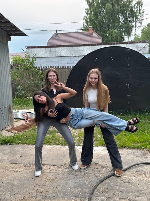 Friends goofing off near a satellite dish in Perm