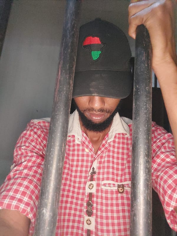 Bearded person in checkered shirt observed in Dar es-Salaam