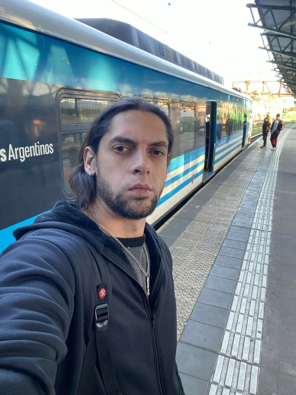 Man waits on Buenos Aires train platform evening rush