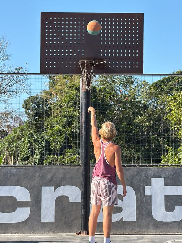 Outdoor basketball in Mengwi with a kite overhead