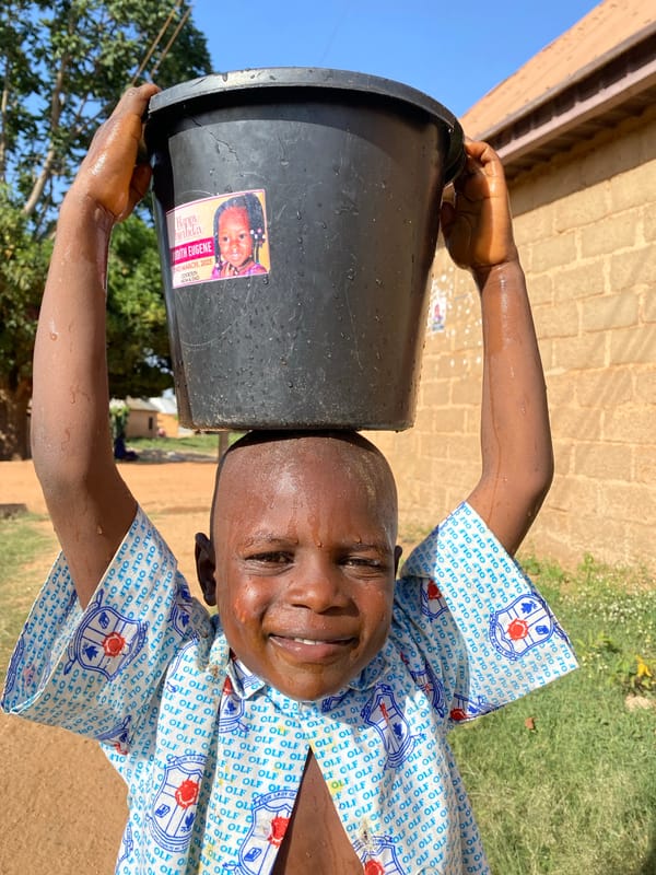 Child plays with bucket in Kuru Dungus, Nigeria