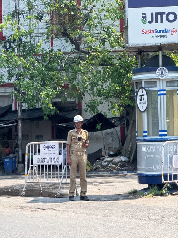 Morning street activity and truck procession observed in Kolkata