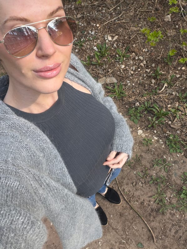 Woman in gray cardigan documented across Perm locations