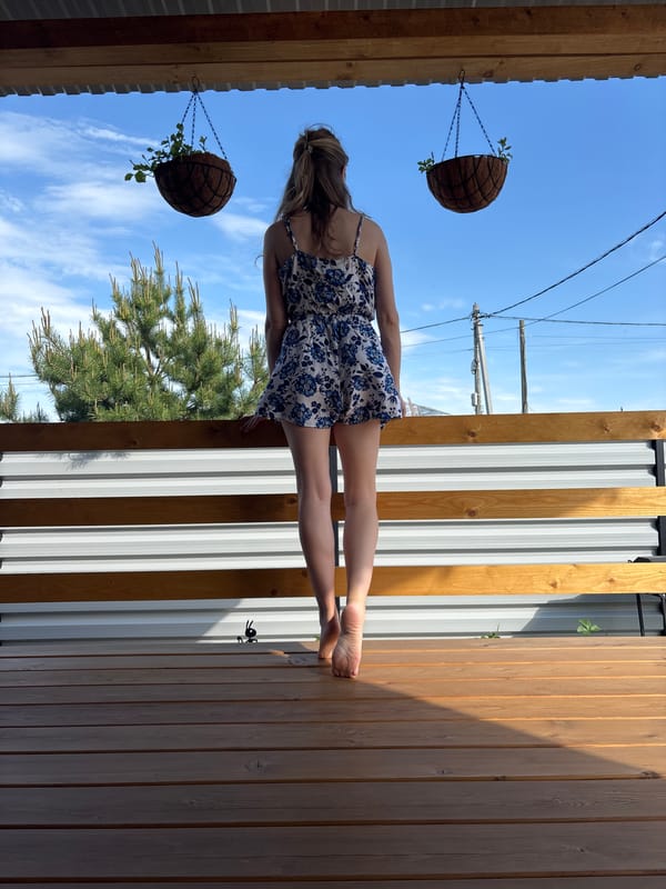 Woman poses for outdoor photo session on wooden deck