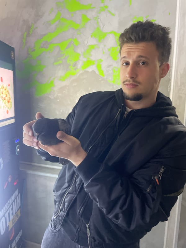 Young man photographed with pigeon in Razgrad, Bulgaria
