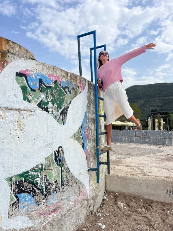 Woman relaxes on railing in Budva, Montenegro