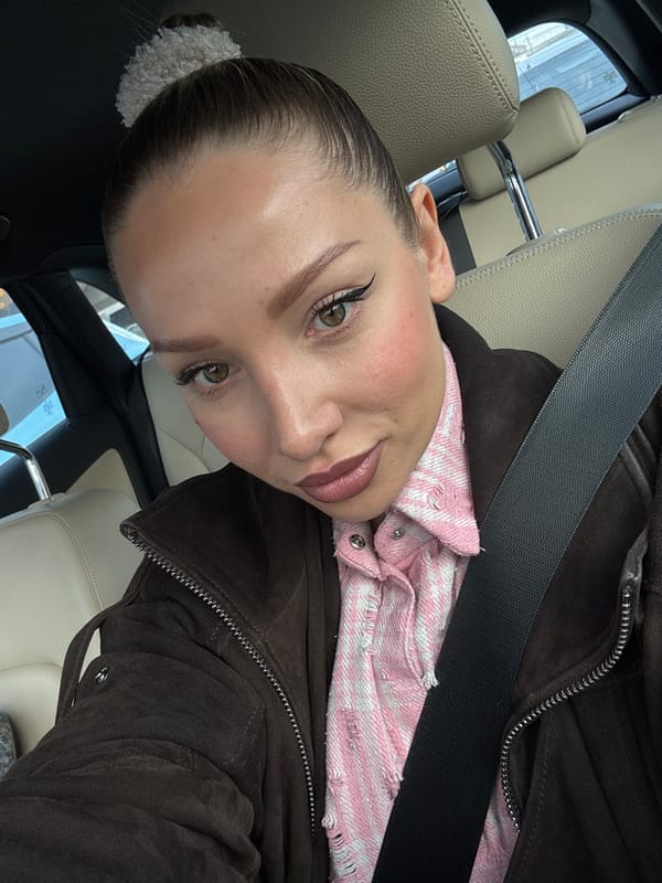 Person captures selfie with distinctive makeup and hairstyle