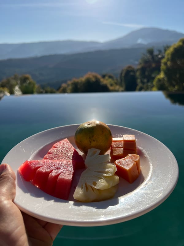 Villa breakfast spread with fruit and eggs, Busungbiu