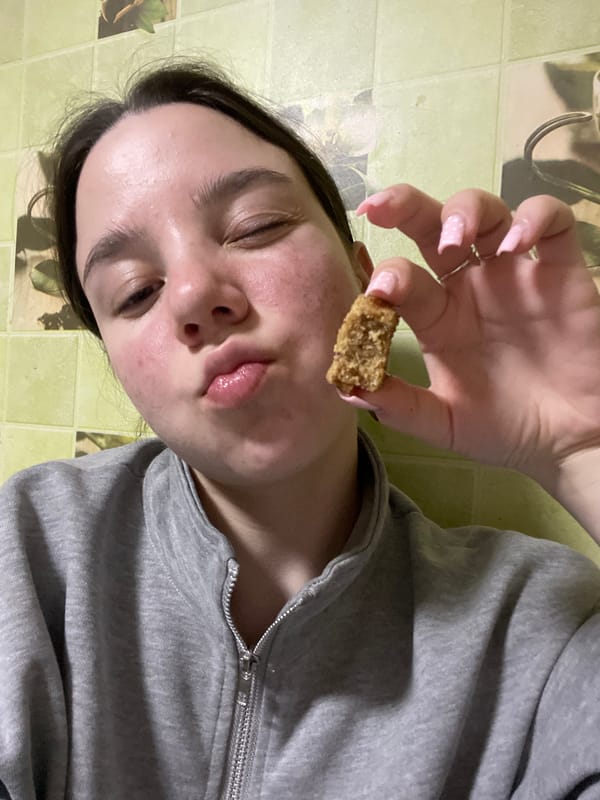 Young person holds food item in Ольховка, Russia