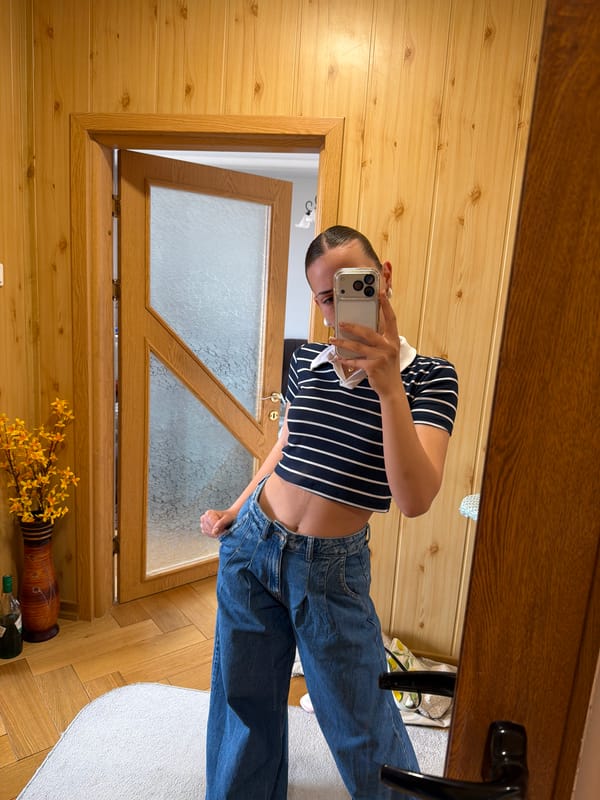 Woman takes selfies in wood-paneled room in Bulgaria