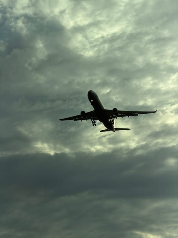 Passenger jet in silhouette over Saint Petersburg skies