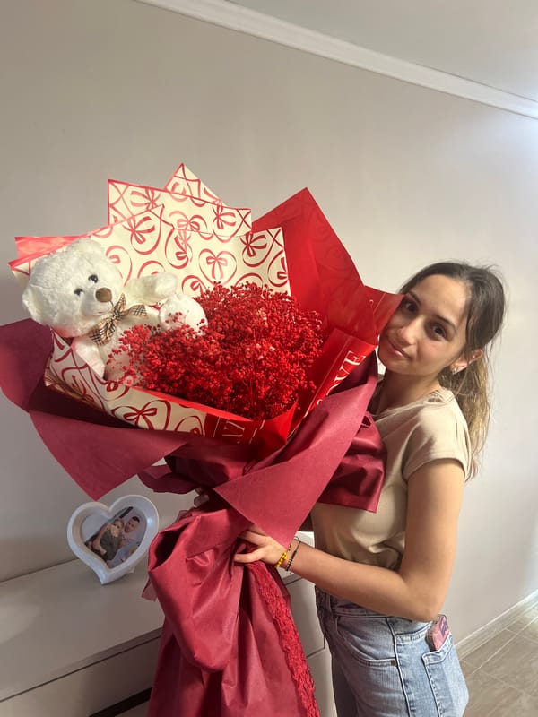 Woman receives roses and teddy bear in Sliven bedroom