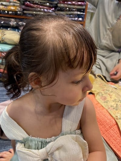 Young child observed in textile shop in Kandahar