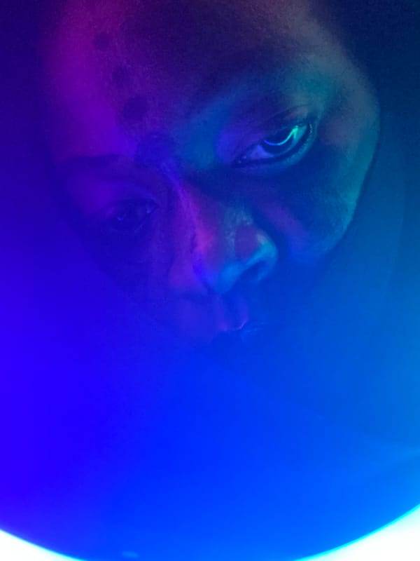 Person experiments with colorful ring lighting in Nigeria
