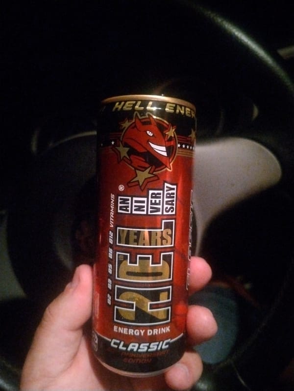 Driver holds energy drink in car in Yambol, Bulgaria