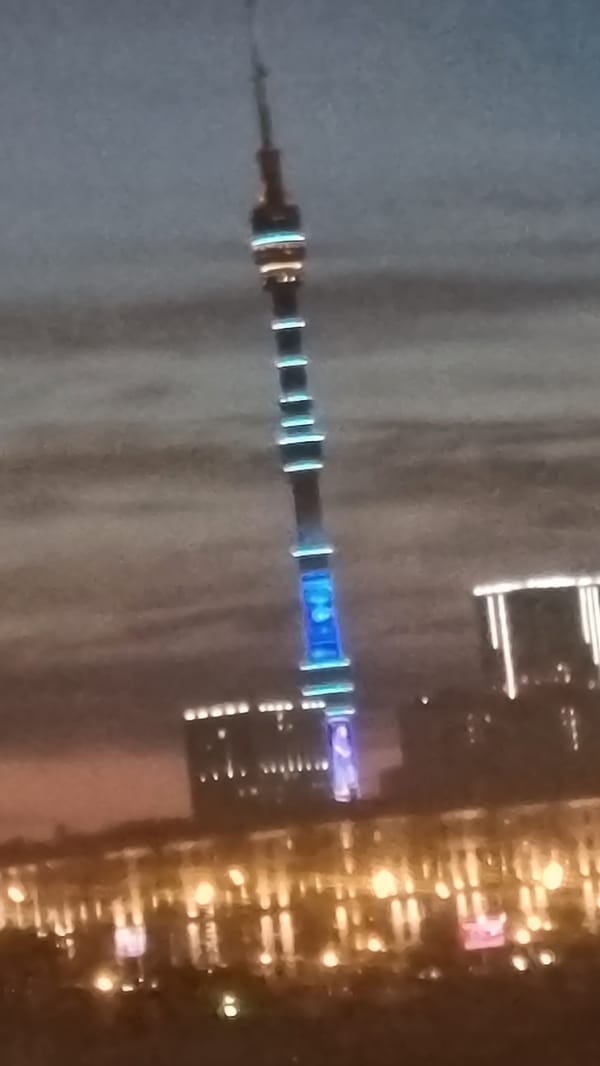 Ostankino Tower glows blue and white over Moscow at night