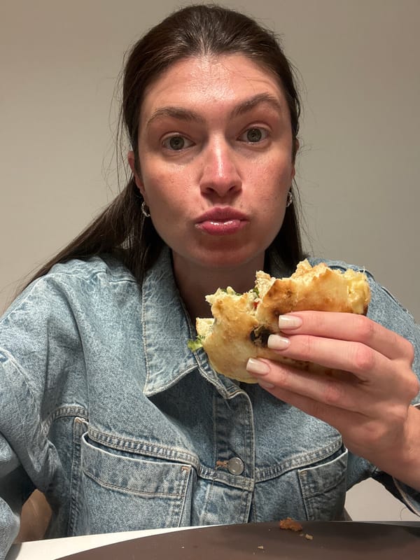 Woman enjoys sandwich meal in Podgorica, Montenegro