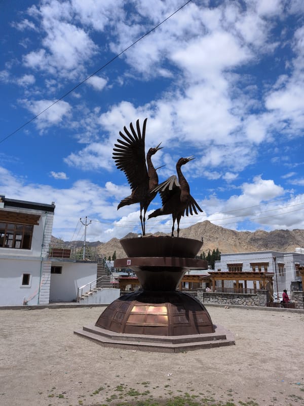 Bronze crane sculpture anchors a public square in Leh