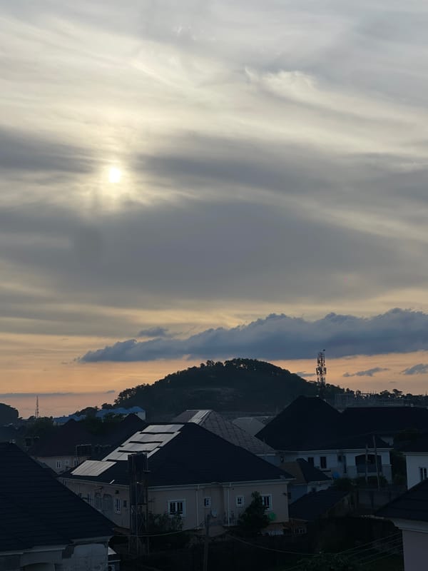 Hazy sunset sky over Abuja residential neighborhood