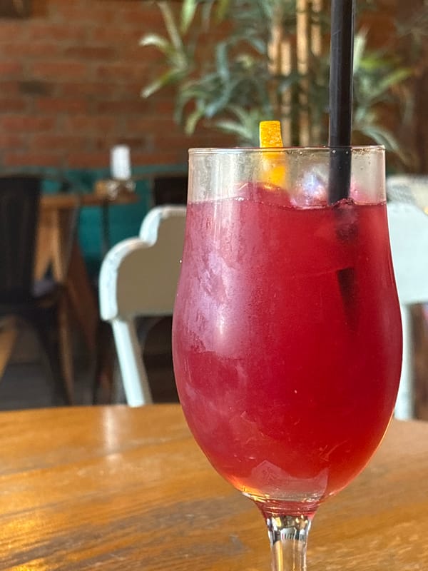 Red cocktail on a wooden table at a Kragujevac café