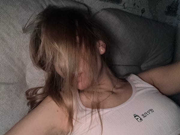 Person resting on sofa captured in Ust-Ilimsk home