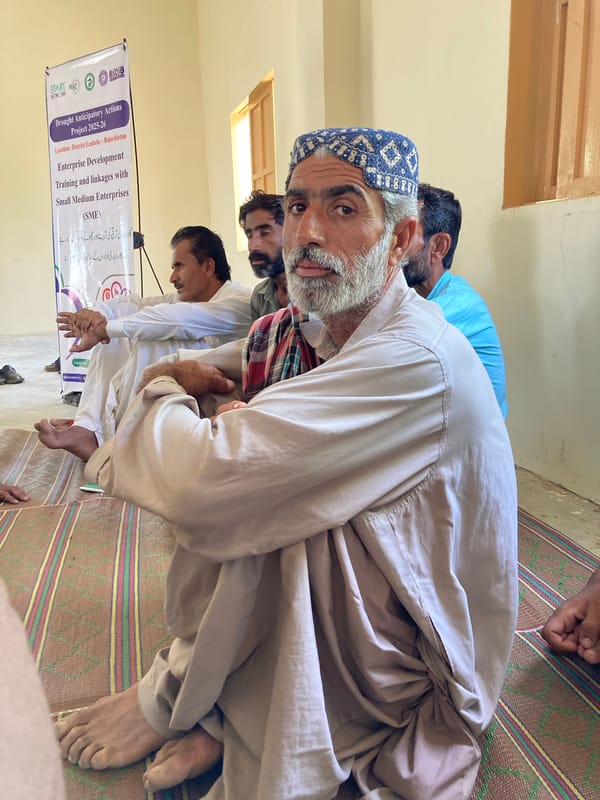 Community gathering with childcare and education in Pakistani village