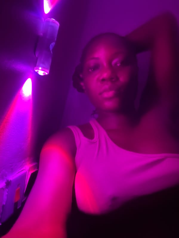 Private gathering with drinks and purple lighting in Nigeria