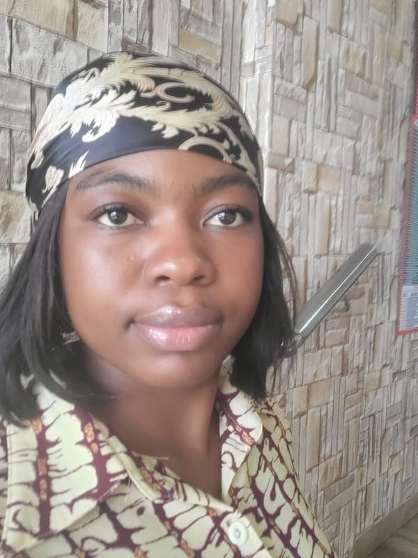 Woman in headscarf documented during office meeting in Nigeria