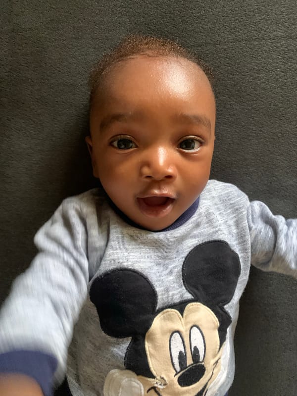 Baby in Mickey Mouse shirt observed in Nigeria