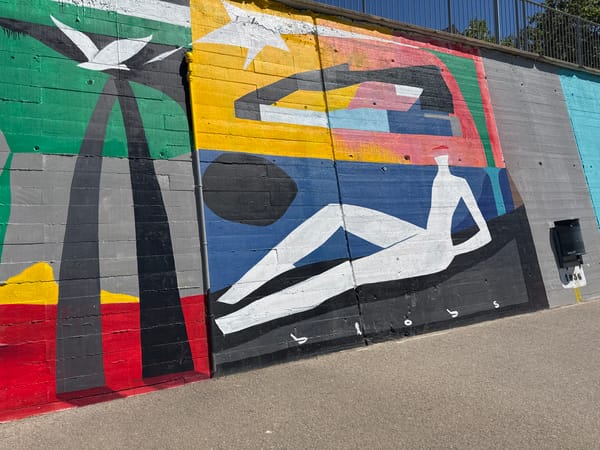 Colorful murals spotted on concrete wall in Sant Adrià