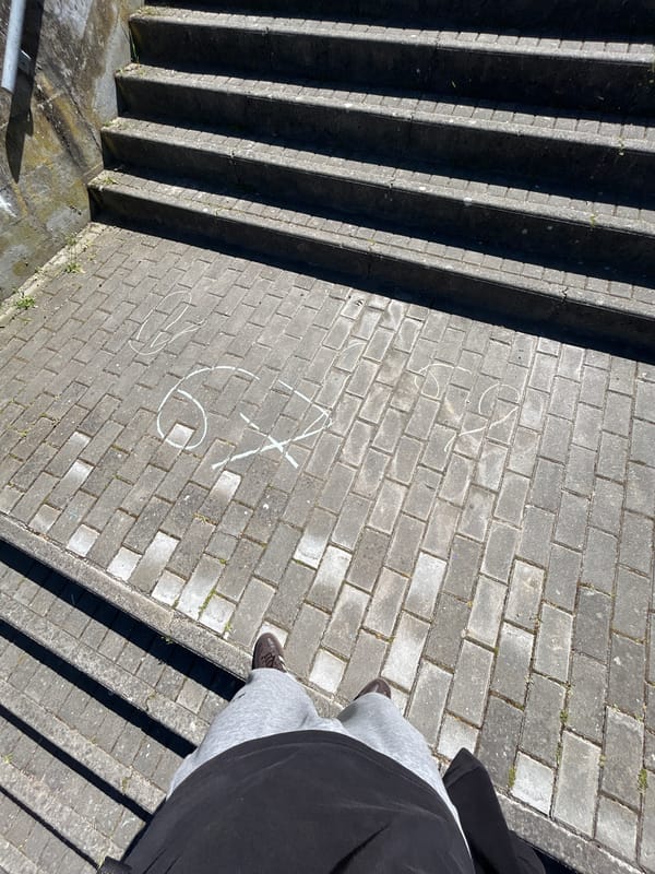 Person with backpack stands on concrete steps in Mirandela