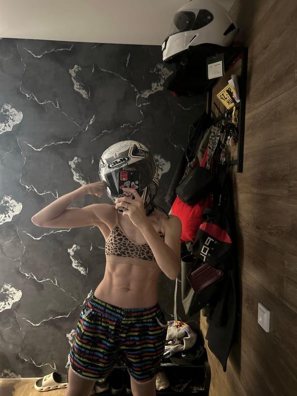 Helmet on, flexing — plus an orange cat stealing the show