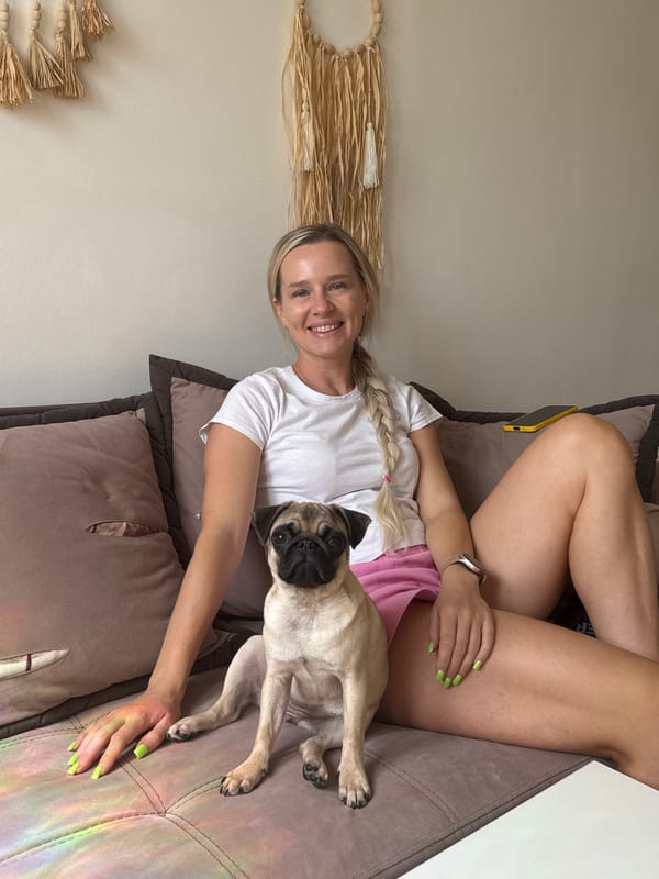 Casual couch moment with a pug, all smiles.