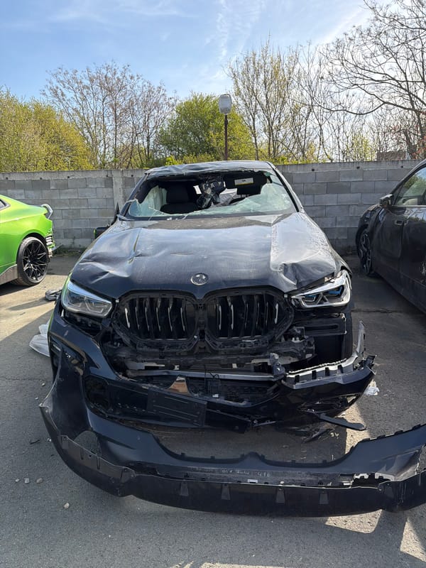 Damaged BMW SUV spotted at automotive facility