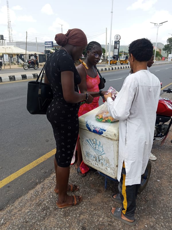 Street vendors serve customers in Nigerian communities