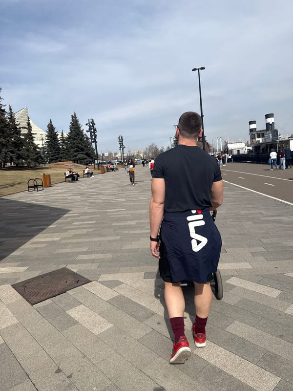 Man rides wheeled device on Krasnoyarsk pavement