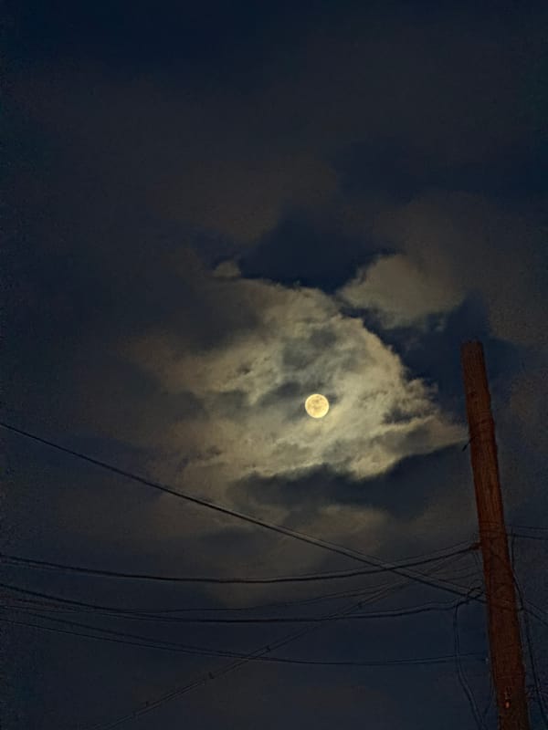 Full moon observed through clouds in Dobrich, Bulgaria