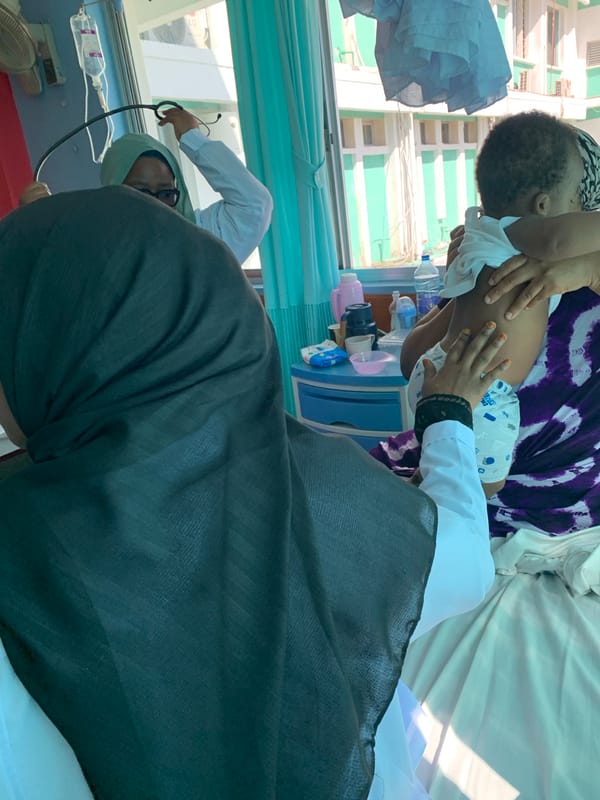 Woman poses with WHO medical books in Dar es-Salaam