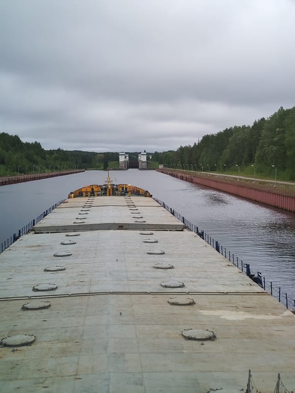 Barge transits canal lock on Volga-Baltic Waterway near Markovo