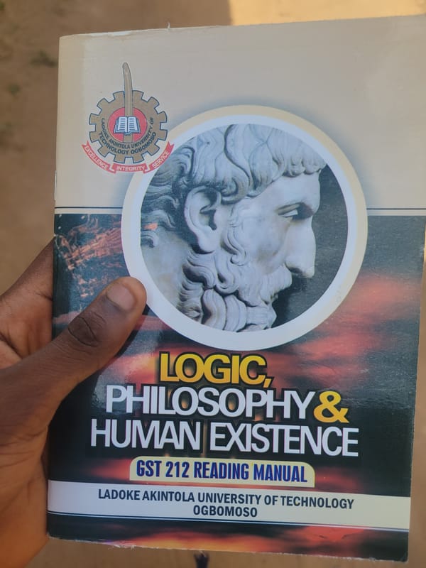 Philosophy textbook and sharp neon logo, same afternoon