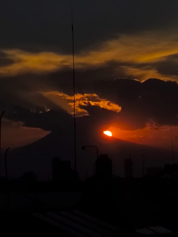 Sunset over Puebla cityscape with Popocatépetl volcano backdrop