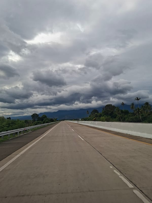 Ominous clouds gather over highway in Baksukon, Indonesia