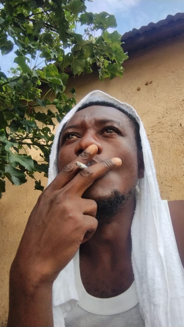 Smoking break in a Jos residential neighborhood, morning