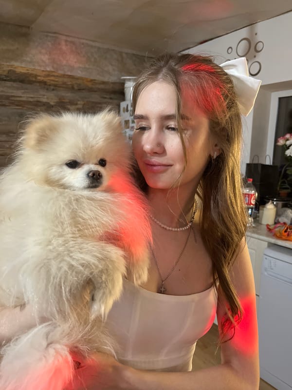 Woman holds fluffy white dog in tender indoor moment
