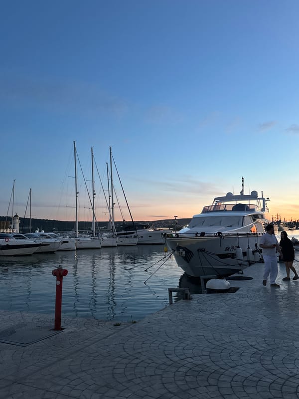 Luxury cars gather at Varna marina during sunset