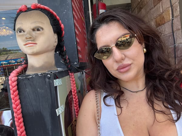 Woman poses with wig mannequins in Patong selfies
