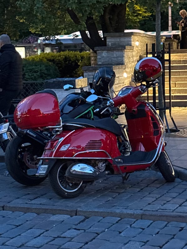 Evening motorcycle gathering in Tallinn Old Town cobblestone streets