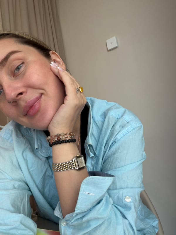 Woman takes selfie near Moscow buildings on Sunday morning