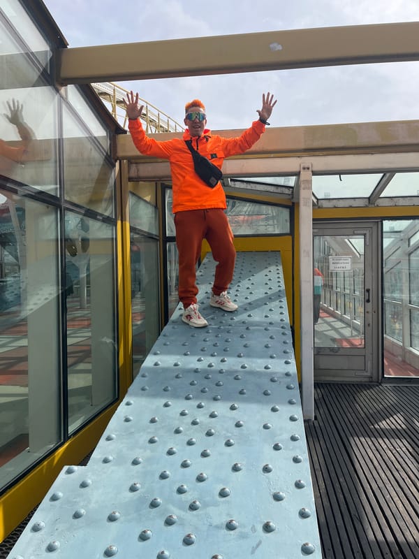Colorful-dressed person poses on Moscow walkway near GUM store